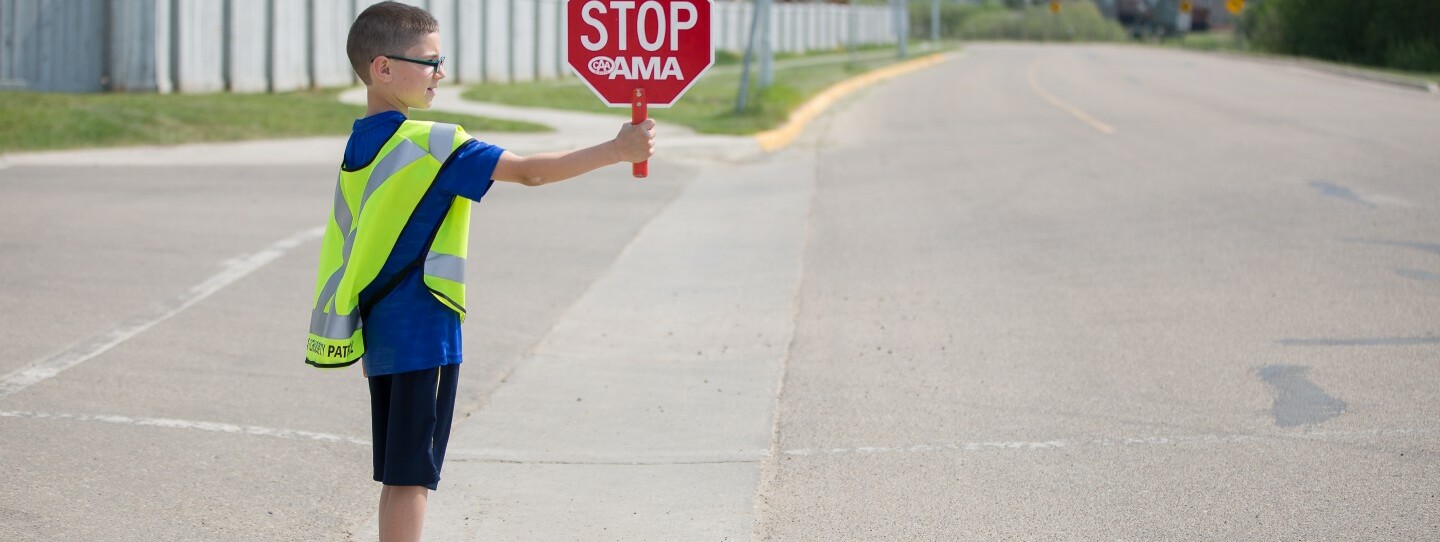 student holding a stop sign
